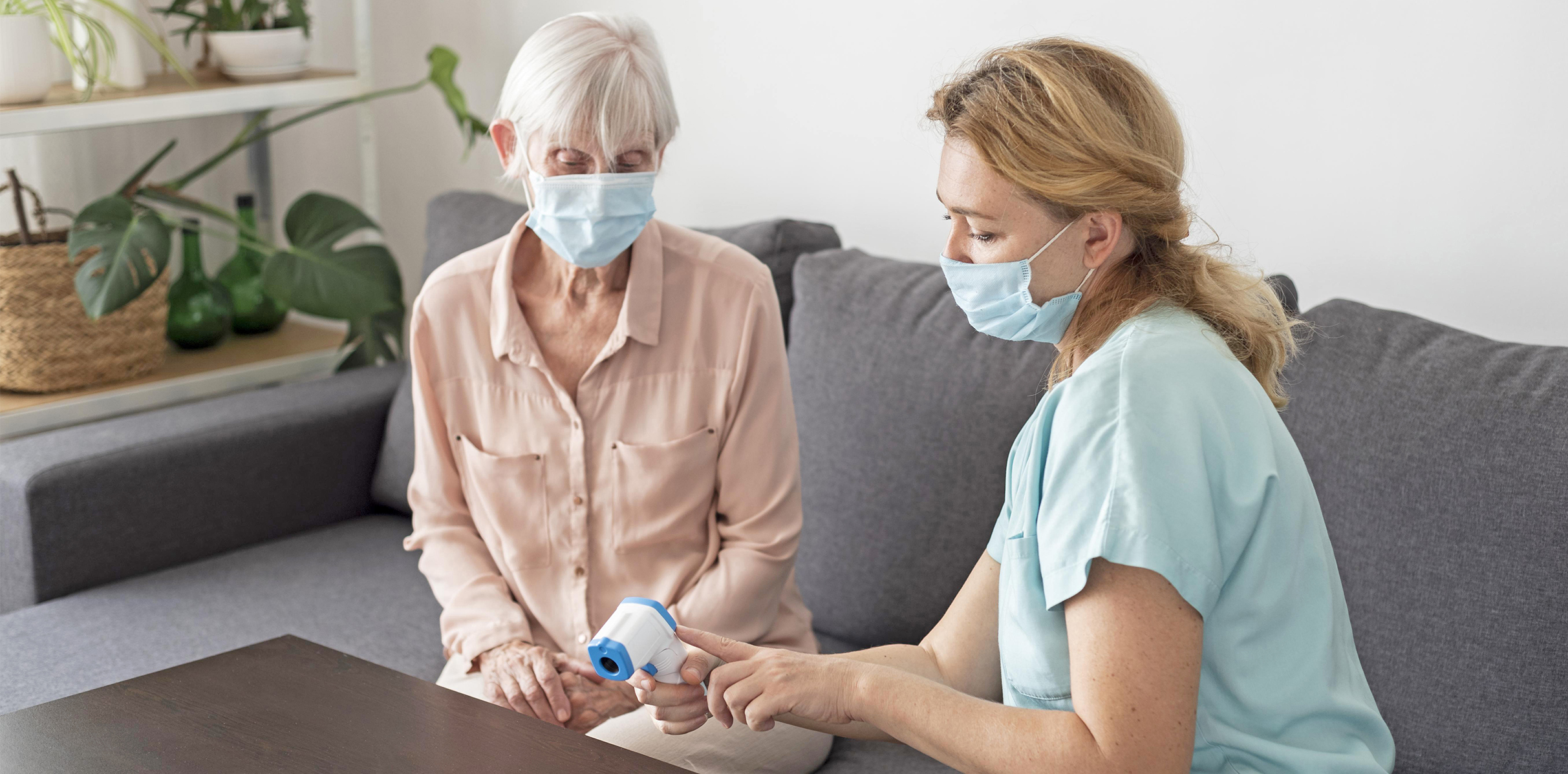 female-nurse-showing-ologgggdaer-woman-nursing-home-electronic-thermometer